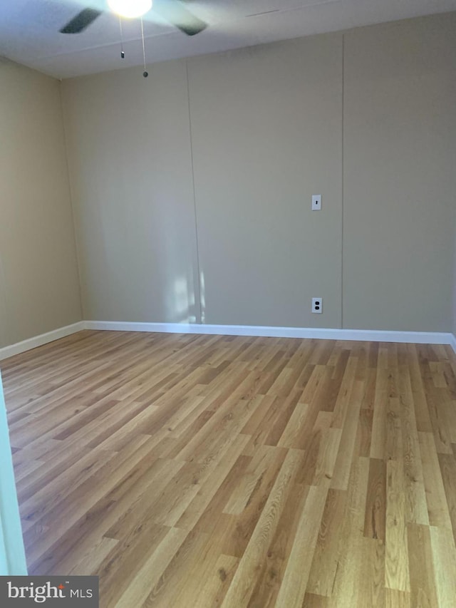 empty room with light hardwood / wood-style flooring and ceiling fan