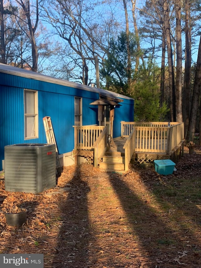 view of front of property with a deck and central AC