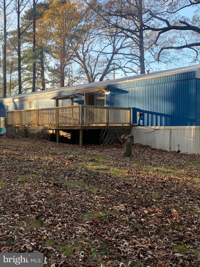 rear view of property with a wooden deck