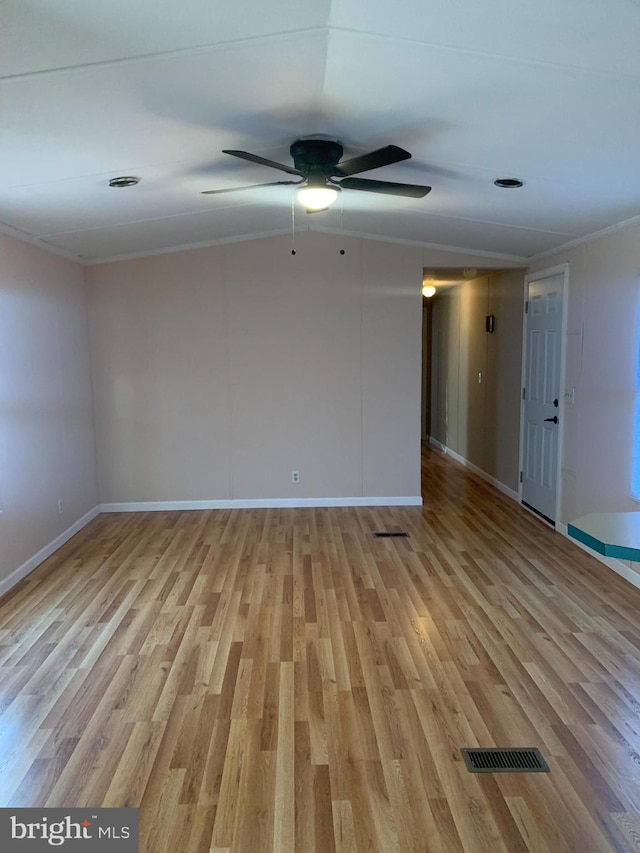 spare room featuring ceiling fan, ornamental molding, and light hardwood / wood-style flooring