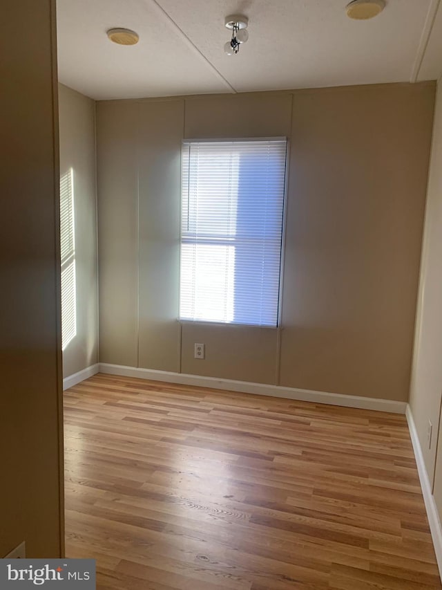 unfurnished room with light hardwood / wood-style floors