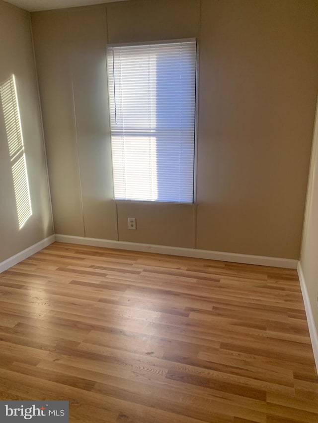 spare room featuring light wood-type flooring