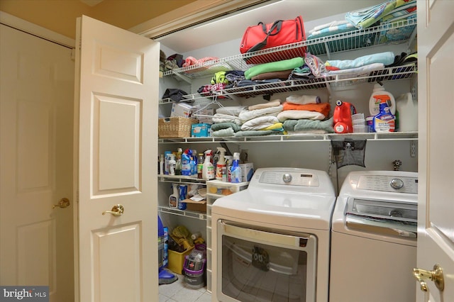 clothes washing area featuring washing machine and clothes dryer and tile patterned flooring