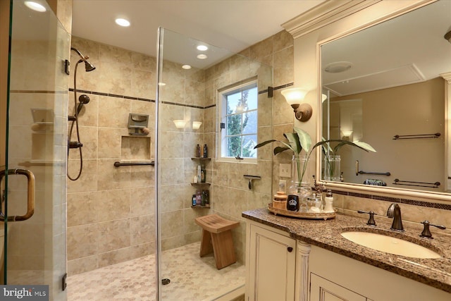 bathroom with vanity and a shower with shower door