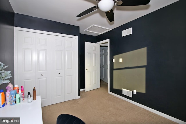 bedroom with a closet, light colored carpet, and ceiling fan