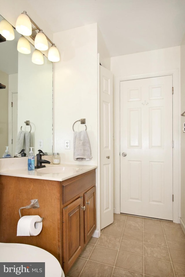 bathroom with tile patterned floors and vanity