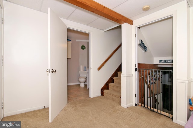 stairway with carpet floors and vaulted ceiling