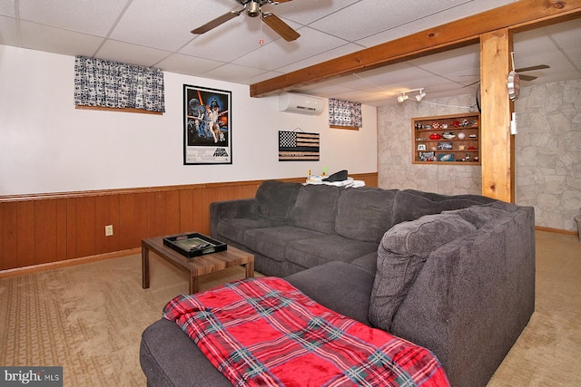 living room featuring a paneled ceiling, ceiling fan, light colored carpet, and a wall mounted AC