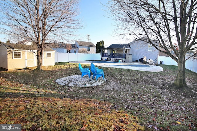 view of yard featuring a patio area and a storage shed