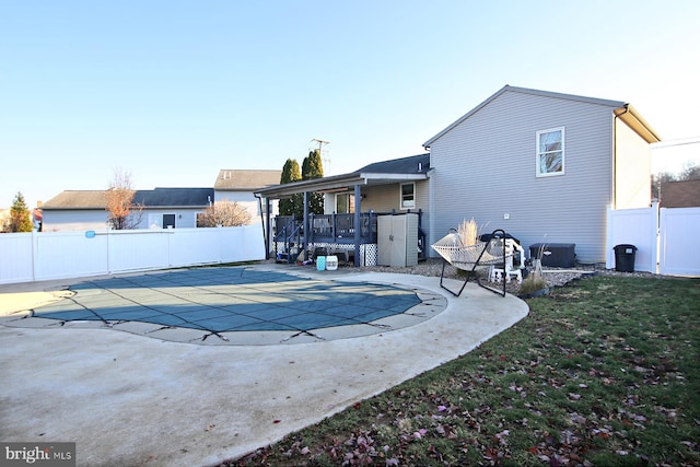 back of house with a patio and a covered pool