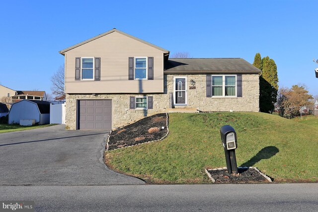 tri-level home with a garage and a front yard