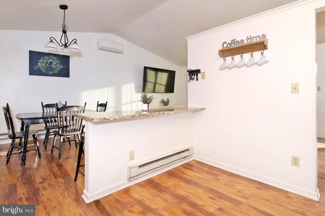 kitchen featuring pendant lighting, a baseboard radiator, and hardwood / wood-style floors