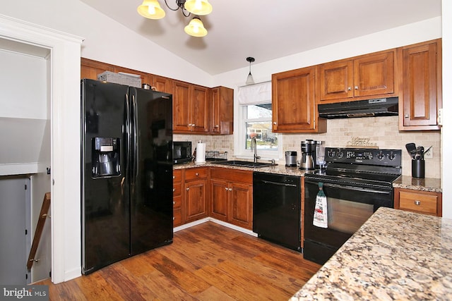 kitchen featuring sink, dark wood-type flooring, lofted ceiling, and black appliances