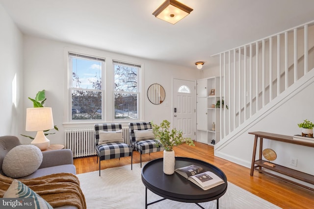 living room with wood-type flooring and radiator heating unit