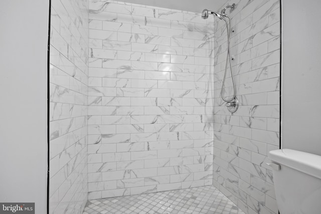 bathroom featuring toilet and tiled shower