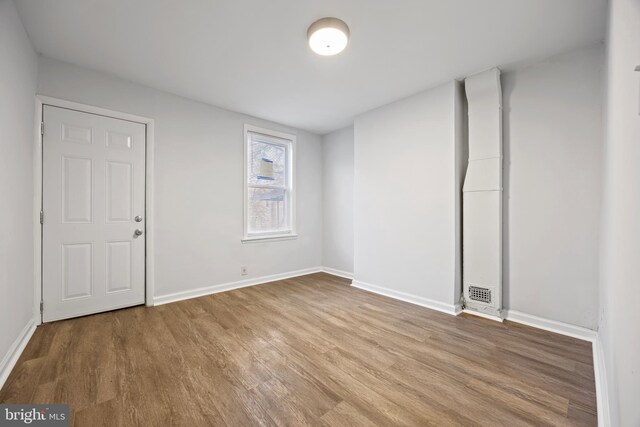 spare room with hardwood / wood-style flooring