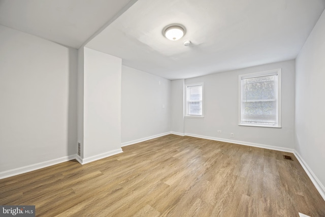 unfurnished room with light hardwood / wood-style flooring