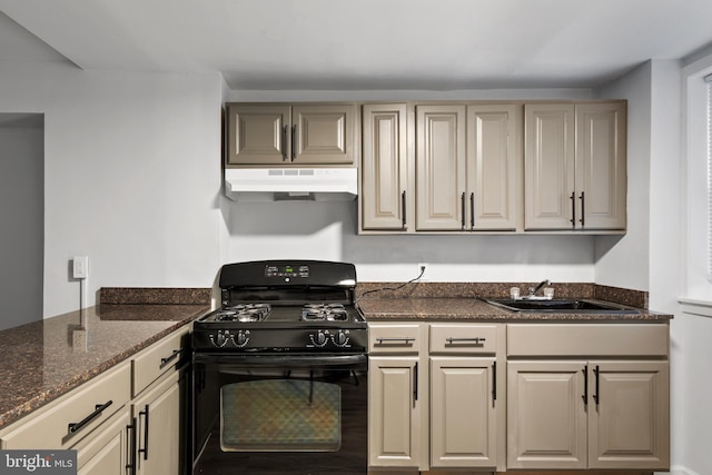 kitchen with sink, black range with gas cooktop, and dark stone counters