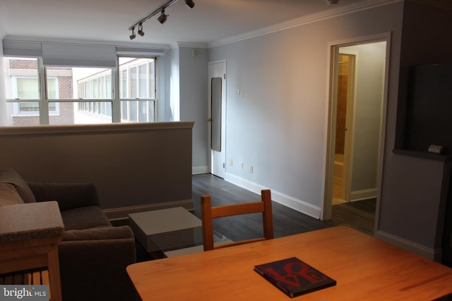 living room featuring crown molding, dark wood-type flooring, and track lighting