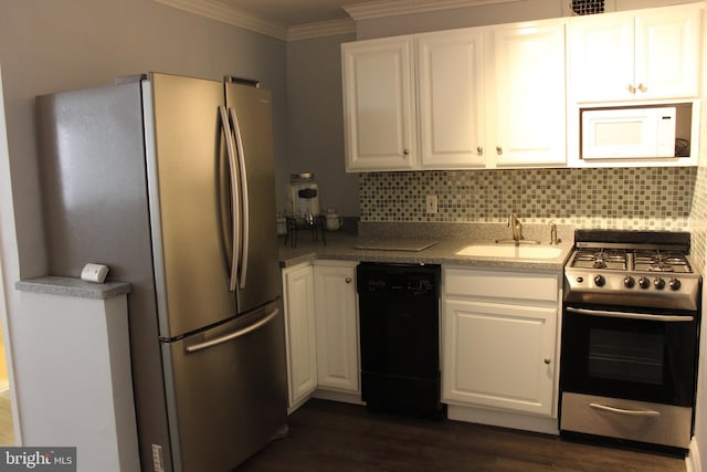 kitchen with white cabinetry, sink, dark wood-type flooring, tasteful backsplash, and appliances with stainless steel finishes