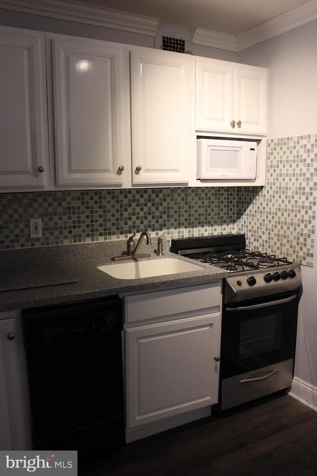 kitchen featuring tasteful backsplash, stainless steel gas range oven, dark wood-type flooring, dishwasher, and white cabinetry