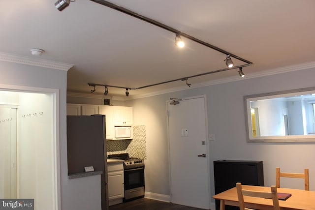 kitchen featuring refrigerator, white cabinetry, ornamental molding, and stainless steel range with gas stovetop