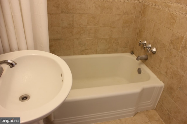 bathroom with shower with separate bathtub, tile patterned floors, and sink