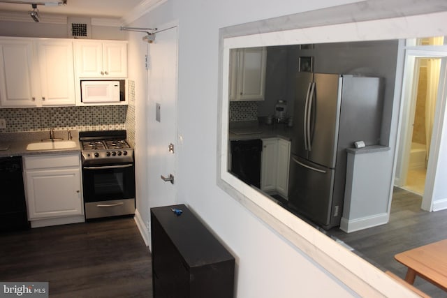 kitchen featuring decorative backsplash, sink, white cabinetry, and stainless steel appliances