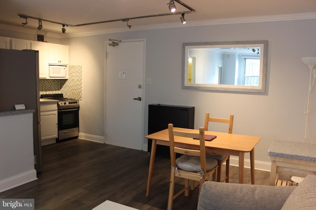 dining area with crown molding and dark wood-type flooring