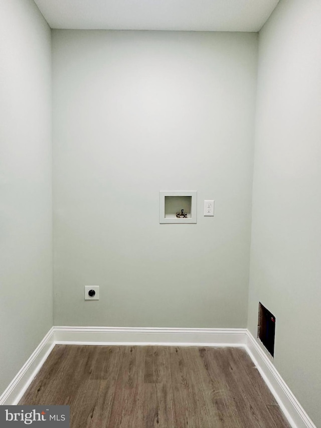 washroom with hookup for an electric dryer, wood-type flooring, and hookup for a washing machine