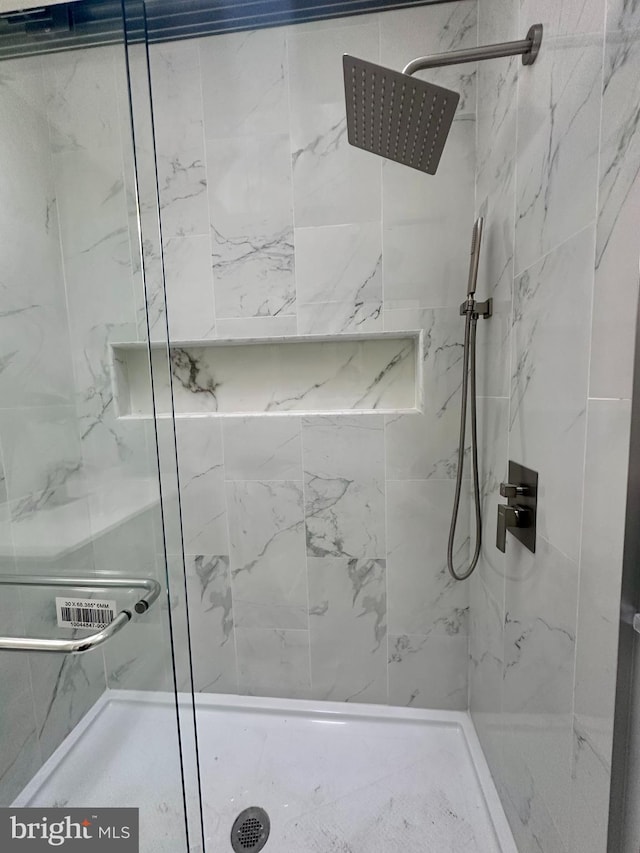 bathroom with tiled shower