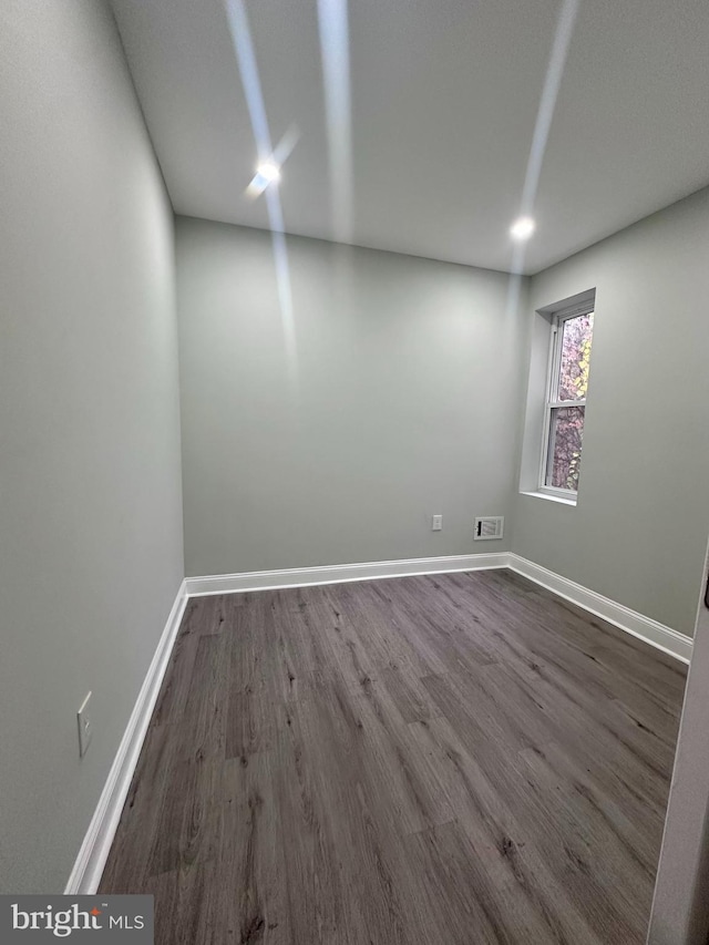 empty room with dark hardwood / wood-style floors