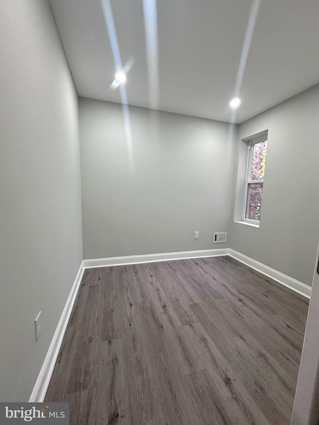 unfurnished room with hardwood / wood-style floors