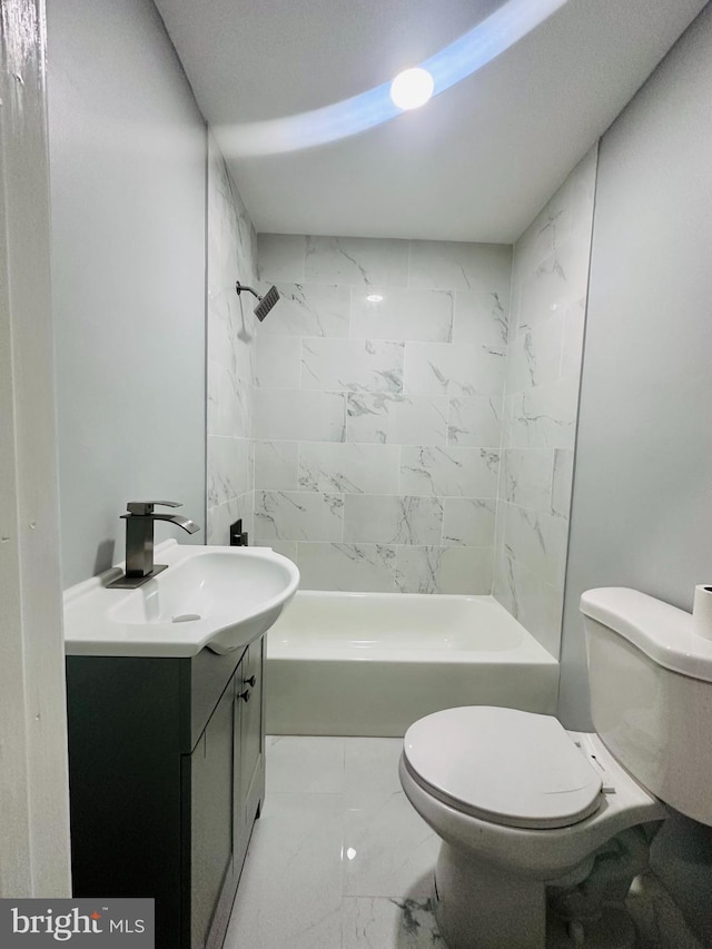 full bathroom with tiled shower / bath, vanity, and toilet