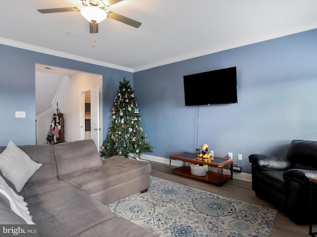 living room featuring hardwood / wood-style floors, ceiling fan, and ornamental molding