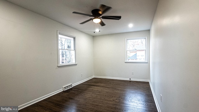 unfurnished room with ceiling fan and dark hardwood / wood-style flooring