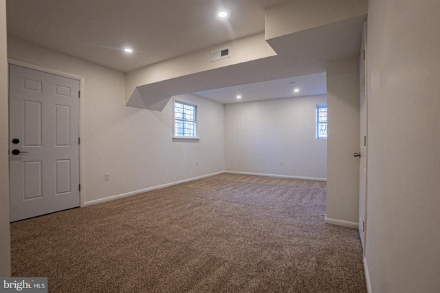 basement featuring a healthy amount of sunlight and carpet flooring