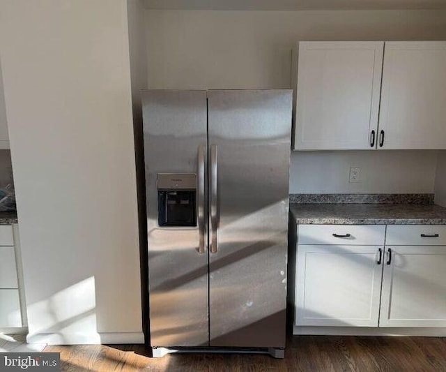 kitchen with dark hardwood / wood-style flooring, white cabinetry, and stainless steel fridge with ice dispenser