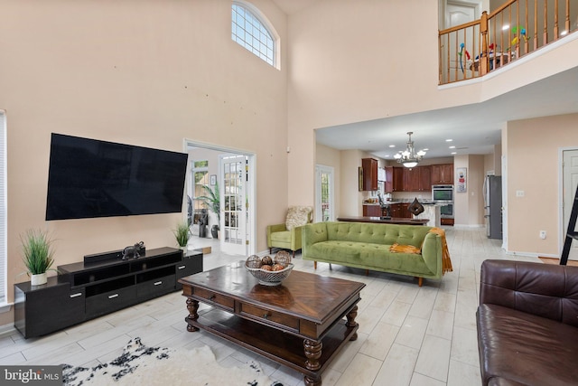 living room featuring a high ceiling and an inviting chandelier