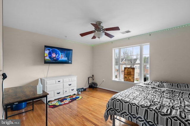 bedroom with ceiling fan and wood-type flooring