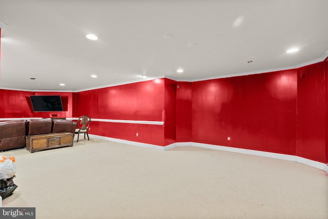 home theater room with light carpet and ornamental molding