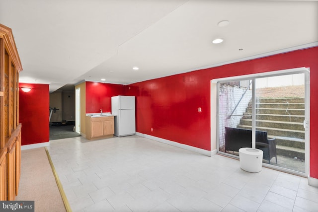 unfurnished living room featuring sink