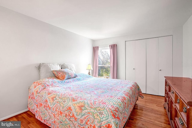 bedroom with a closet and light hardwood / wood-style flooring