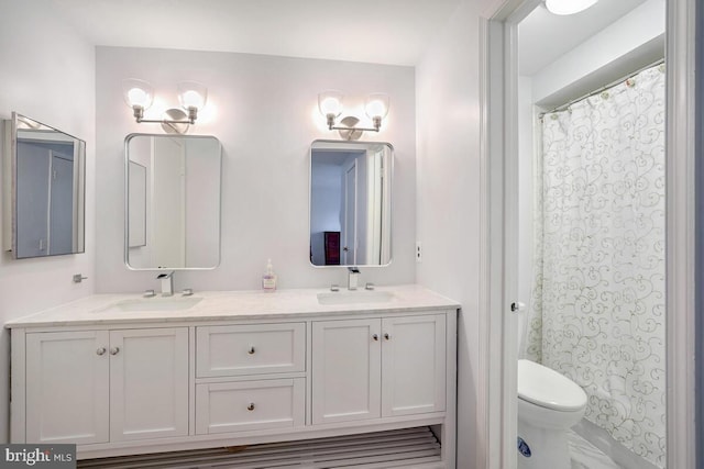 bathroom featuring a shower with shower curtain, vanity, and toilet