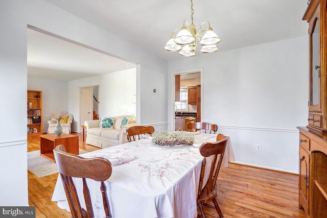 dining room with a notable chandelier and light hardwood / wood-style floors