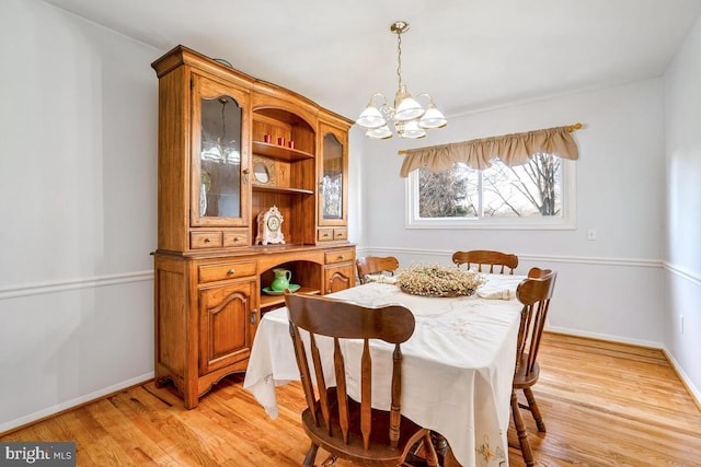 dining space featuring a notable chandelier and light hardwood / wood-style flooring