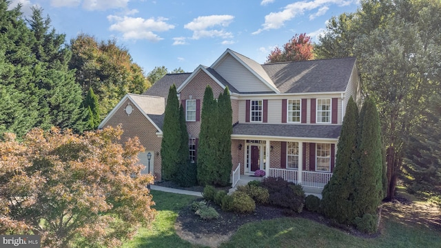 view of front of house featuring covered porch and a front yard