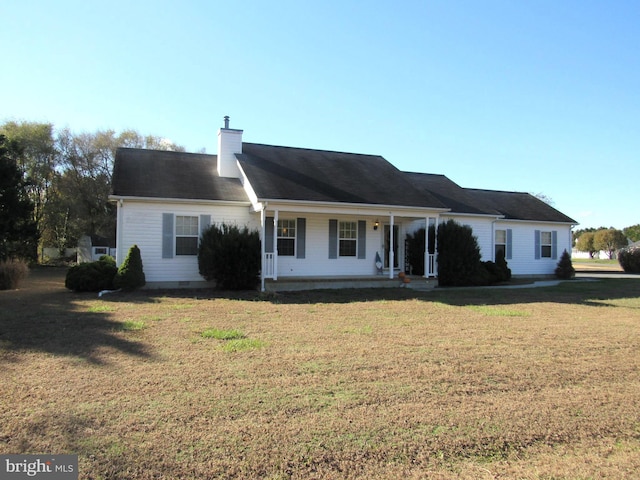 single story home featuring covered porch and a front yard