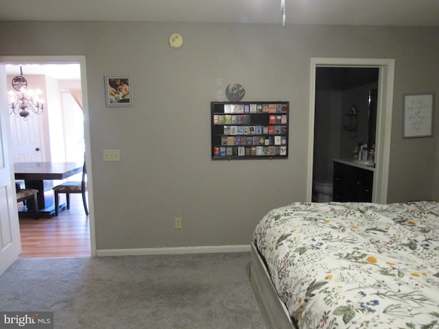 carpeted bedroom with an inviting chandelier