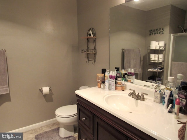 bathroom featuring tile patterned floors, vanity, and toilet